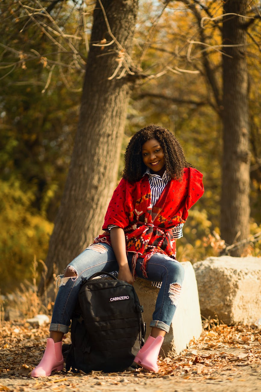 selective focus photography of woman sitting on gray concrete block