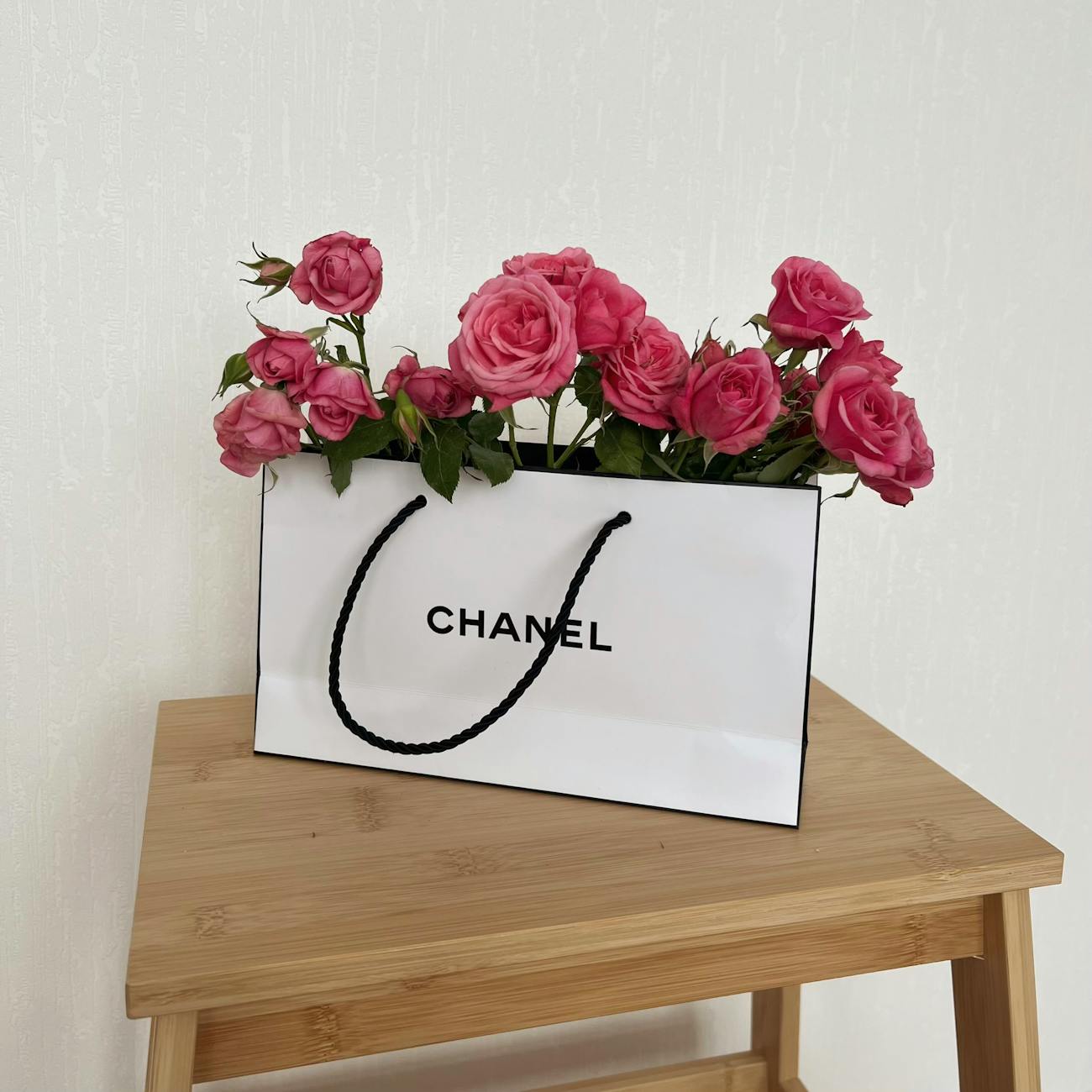 pink roses in a paper bag